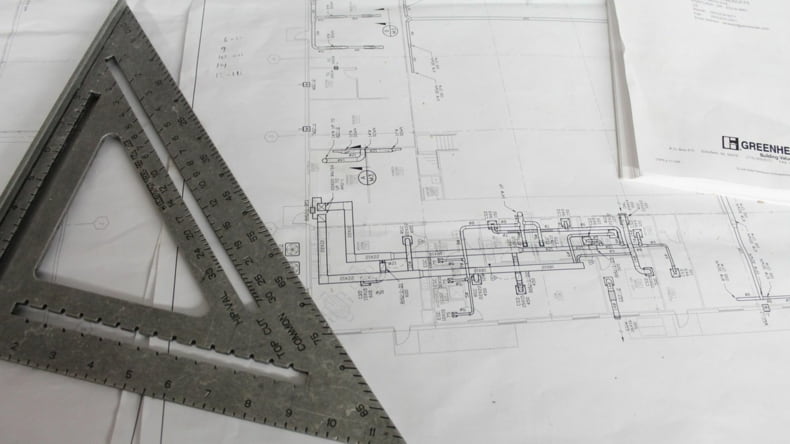 Imagen de un plano que hace referencia a su importancia en una construcción de obra nueva